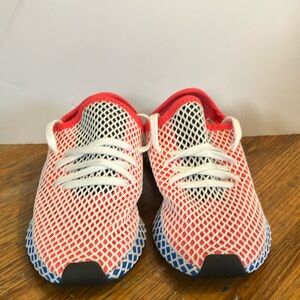 Pink, white, and blue athletic adidas shoes